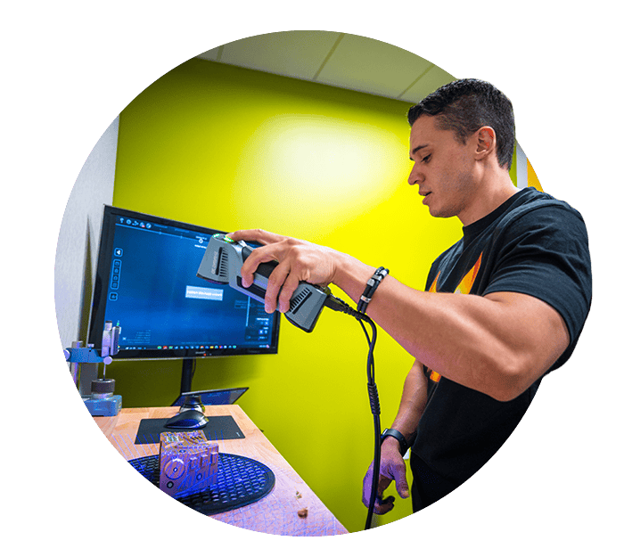 Young man 3-D scanning an object
