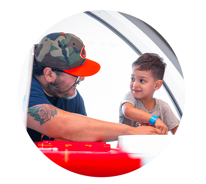 A dad and son playing with toy car