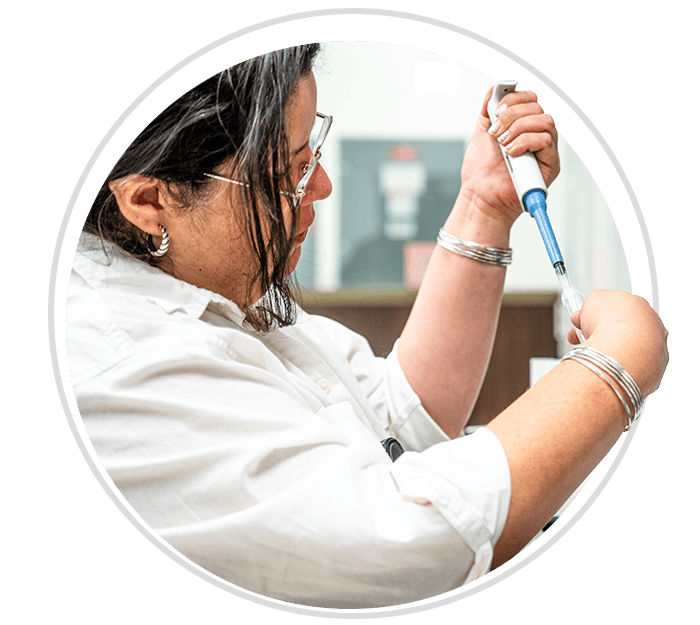 Woman placing liquid into tube