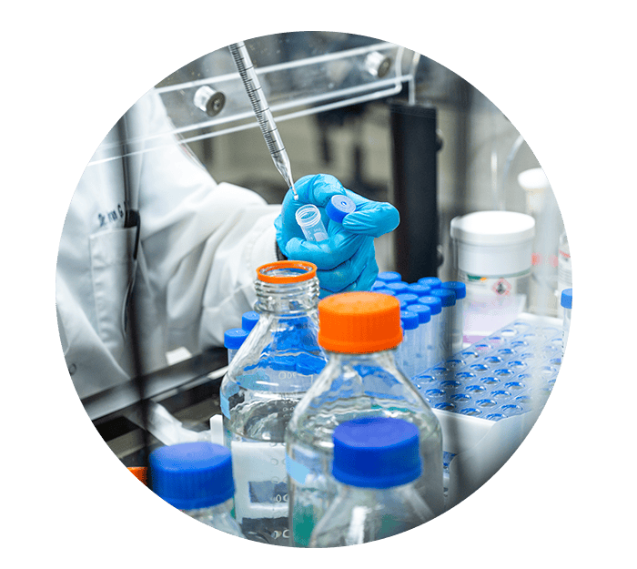 Liquid being poured into vial.