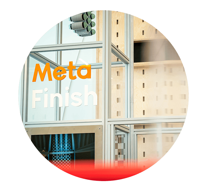 Glass office door with logo saying Meta Finish